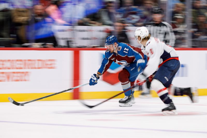 Nov 15, 2024; Denver, Colorado, USA; Colorado Avalanche right wing Valeri Nichushkin (13) controls the puck against Washington Capitals defenseman Jakob Chychrun (6) in the second period at Ball Arena. Mandatory Credit: Isaiah J. Downing-Imagn Images