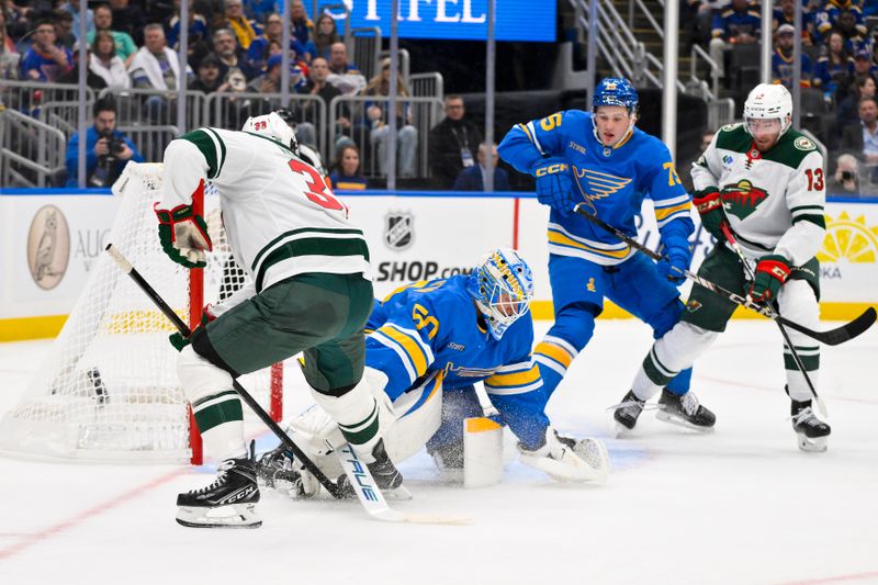 Oct 9, 2025; St. Louis, Missouri, USA; Minnesota Wild right wing Ryan Hartman (38) scores against St. Louis Blues goaltender Jordan Binnington (50) during the first period at Enterprise Center. Mandatory Credit: Jeff Curry-Imagn Images