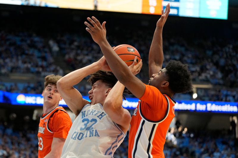 Jan 13, 2024; Chapel Hill, North Carolina, USA;  North Carolina Tar Heels forward James Okonkwo (32) with the ball as Syracuse Orange guard Kyle Cuffe Jr. (0) defends in the second half at Dean E. Smith Center. Mandatory Credit: Bob Donnan-USA TODAY Sports