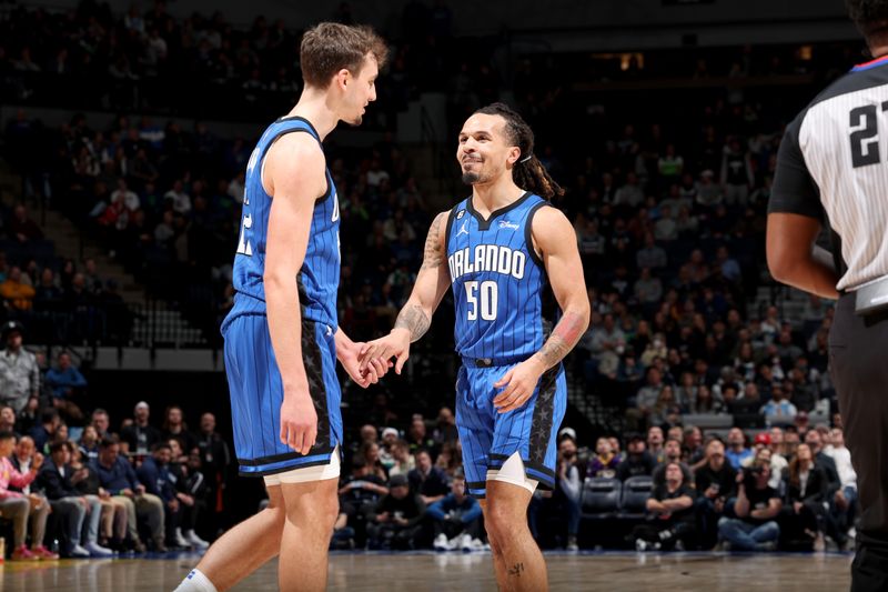 MINNEAPOLIS, MN -  FEBRUARY 3: Franz Wagner #22 and Cole Anthony #50 of the Orlando Magic high fives during the game against the Minnesota Timberwolves on February 3, 2023 at Target Center in Minneapolis, Minnesota. NOTE TO USER: User expressly acknowledges and agrees that, by downloading and or using this Photograph, user is consenting to the terms and conditions of the Getty Images License Agreement. Mandatory Copyright Notice: Copyright 2023 NBAE (Photo by David Sherman/NBAE via Getty Images)