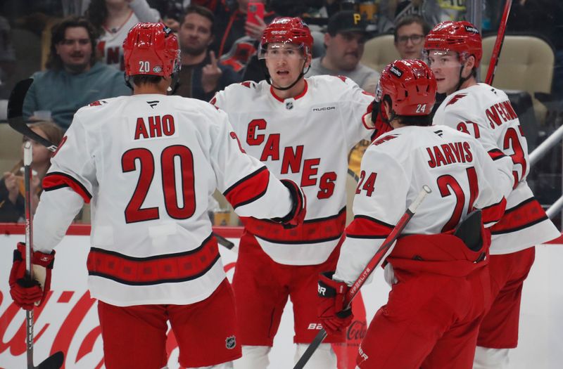 Oct 18, 2024; Pittsburgh, Pennsylvania, USA;  Carolina Hurricanes center Sebastian Aho (20) and center Seth Jarvis (24) and right wing Andrei Svechnikov (37) congratulate center Martin Necas (88) on his goal against the Pittsburgh Penguins during the second period at PPG Paints Arena. Mandatory Credit: Charles LeClaire-Imagn Images