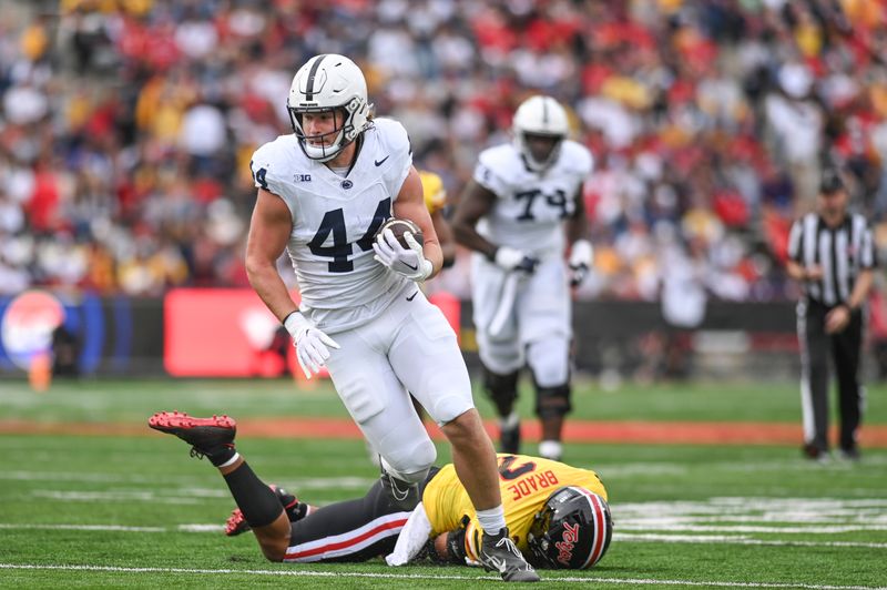 Nov 4, 2023; College Park, Maryland, USA;  Penn State Nittany Lions tight end Tyler Warren (44) runs by Penn State Nittany Lions safety Keaton Ellis (2) during the first half at SECU Stadium. Mandatory Credit: Tommy Gilligan-USA TODAY Sports