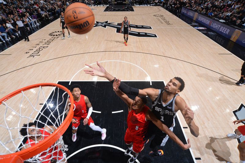 SAN ANTONIO, TX - JANUARY 26: Victor Wembanyama #1 of the San Antonio Spurs rebounds the ball during the game against the Portland Trail Blazers on January 26, 2024 at the Frost Bank Center in San Antonio, Texas. NOTE TO USER: User expressly acknowledges and agrees that, by downloading and or using this photograph, user is consenting to the terms and conditions of the Getty Images License Agreement. Mandatory Copyright Notice: Copyright 2024 NBAE (Photos by Michael Gonzales/NBAE via Getty Images)