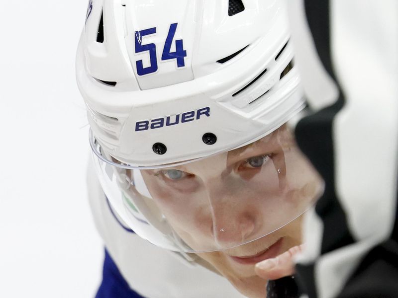 Dec 1, 2024; Detroit, Michigan, USA;  Vancouver Canucks center Aatu Raty (54) gets set to face off in the first period against the Detroit Red Wings at Little Caesars Arena. Mandatory Credit: Rick Osentoski-Imagn Images