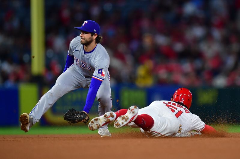 Sep 27, 2024; Anaheim, California, USA; Los Angeles Angels right fielder Gustavo Campero (51) steals second against Texas Rangers shortstop Josh Smith (8) during the fifth inning at Angel Stadium. Mandatory Credit: Gary A. Vasquez-Imagn Images