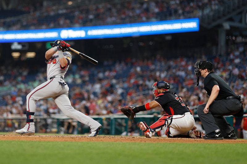 Jun 6, 2024; Washington, District of Columbia, USA; Atlanta Braves third baseman Austin Riley (27) hits an RBI single against the Washington Nationals during the eighth inning at Nationals Park. Mandatory Credit: Geoff Burke-USA TODAY Sports