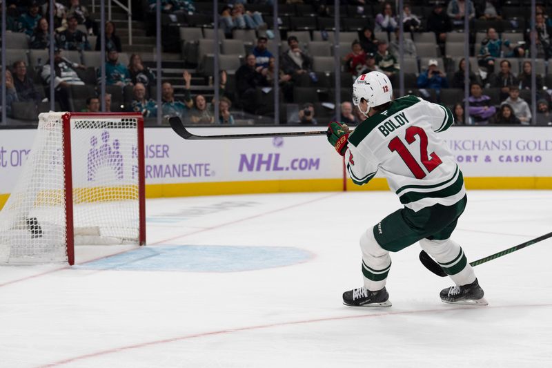 Nov 7, 2024; San Jose, California, USA;  Minnesota Wild left wing Matt Boldy (12) shoots into an open net during the third period against the San Jose Sharks at SAP Center at San Jose. Mandatory Credit: Stan Szeto-Imagn Images