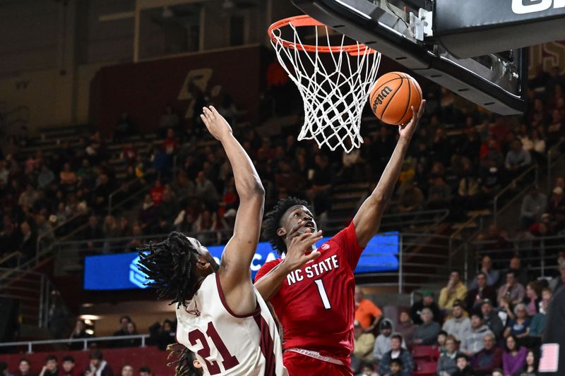 Feb 11, 2023; Chestnut Hill, Massachusetts, USA; North Carolina State Wolfpack guard Jarkel Joiner (1) attempts a layup against Boston College Eagles forward Devin McGlockton (21) during the second half at the Conte Forum. Mandatory Credit: Brian Fluharty-USA TODAY Sports