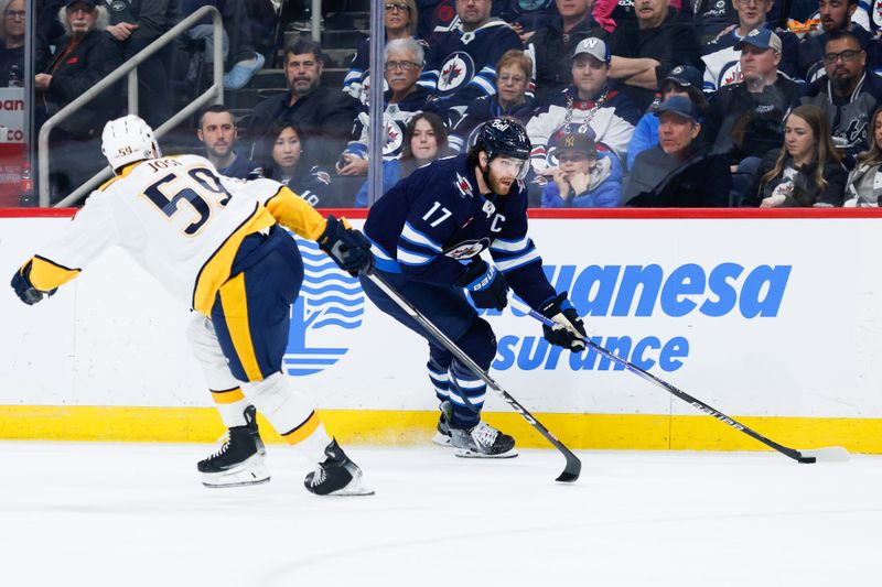 Mar 13, 2024; Winnipeg, Manitoba, CAN; Winnipeg Jets forward Adam Lowry (17) skates away from Nashville Predators defenseman Roman Josi (59) during the second period at Canada Life Centre. Mandatory Credit: Terrence Lee-USA TODAY Sports