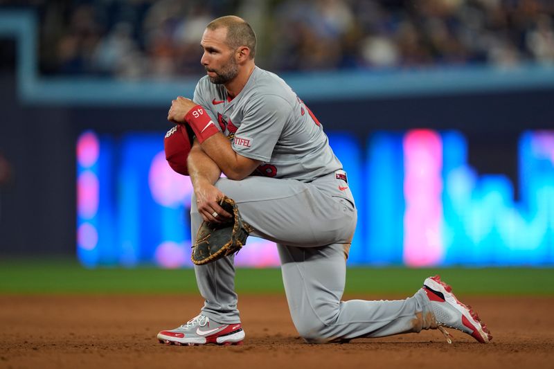 Sep 13, 2024; Toronto, Ontario, CAN; St. Louis Cardinals first baseman Paul Goldschmidt (46) takes a knee during a play review against the Toronto Blue Jays in the ninth inning at Rogers Centre. Mandatory Credit: John E. Sokolowski-Imagn Images