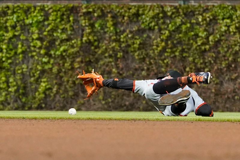 May 5, 2025; Chicago, Illinois, USA; San Francisco Giants second baseman Christian Koss (50) can not make a play on Chicago Cubs third baseman Nicky Lopez (not pictured) infield single during the fourth inning at Wrigley Field. Mandatory Credit: David Banks-Imagn Images