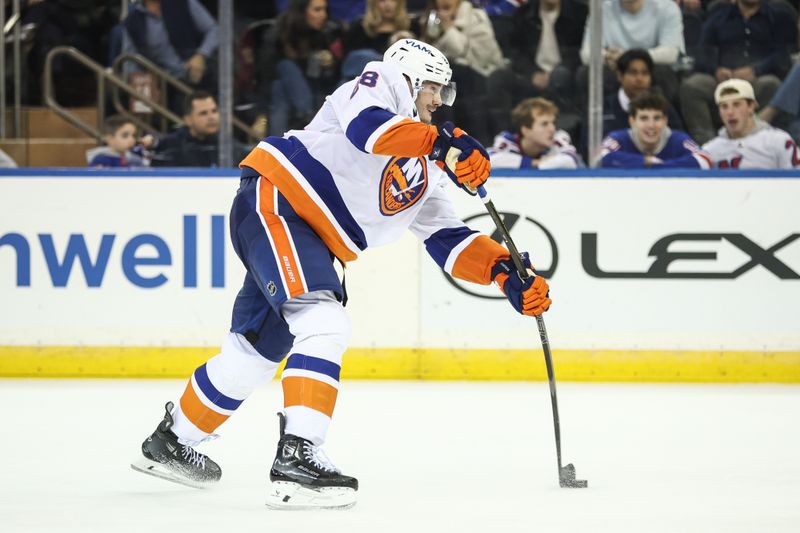 Nov 8, 2025; New York, New York, USA;  New York Islanders defenseman Alexander Romanov (28) attempts a shot on goal in the second period against the New York Rangers at Madison Square Garden. Mandatory Credit: Wendell Cruz-Imagn Images