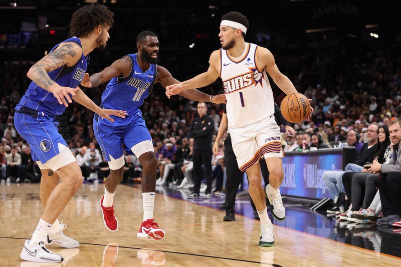 PHOENIX, ARIZONA - DECEMBER 25: Devin Booker #1 of the Phoenix Suns handles the ball against Tim Hardaway Jr. #10 of the Dallas Mavericks during the second half of the NBA game at Footprint Center on December 25, 2023 in Phoenix, Arizona. The Mavericks defeated the Suns 128-114. NOTE TO USER: User expressly acknowledges and agrees that, by downloading and or using this photograph, User is consenting to the terms and conditions of the Getty Images License Agreement.  (Photo by Christian Petersen/Getty Images)