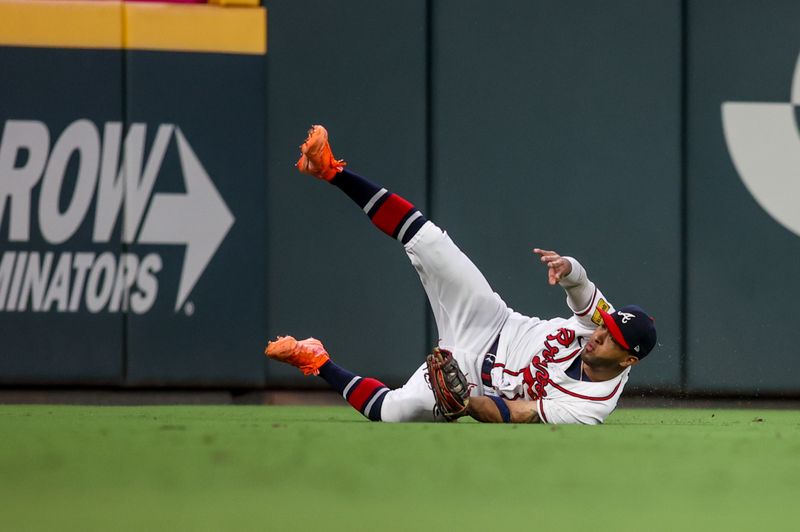 Sep 7, 2023; Atlanta, Georgia, USA; Atlanta Braves left fielder Eddie Rosario (8) makes a diving catch against the St. Louis Cardinals in the ninth inning at Truist Park. Mandatory Credit: Brett Davis-USA TODAY Sports
