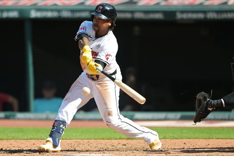 Sep 15, 2024; Cleveland, Ohio, USA; Cleveland Guardians designated hitter Jose Ramirez (11) hits a single during the fifth inning against the Tampa Bay Rays at Progressive Field. Mandatory Credit: Ken Blaze-Imagn Images