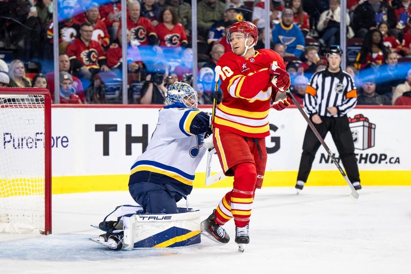 Dec 5, 2024; Calgary, Alberta, CAN; Calgary Flames center Jonathan Huberdeau (10) screens St. Louis Blues goaltender Jordan Binnington (50) during the second period at Scotiabank Saddledome. Mandatory Credit: Brett Holmes-Imagn Images