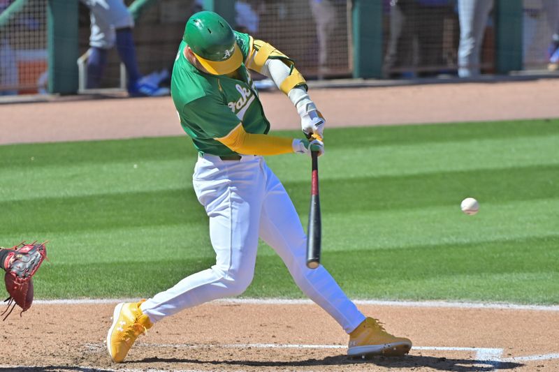 Mar 20, 2024; Mesa, Arizona, USA;  Oakland Athletics left fielder Brent Rooker (25) hits a two run home run in the third inning against the Chicago Cubs during a spring training game at Hohokam Stadium. Mandatory Credit: Matt Kartozian-USA TODAY Sports