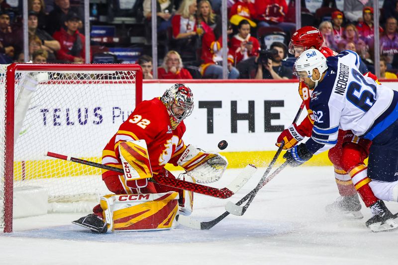 Oct 3, 2025; Calgary, Alberta, CAN; Calgary Flames goaltender Dustin Wolf (32) makes a save against the Winnipeg Jets during the first period at Scotiabank Saddledome. Mandatory Credit: Sergei Belski-Imagn Images