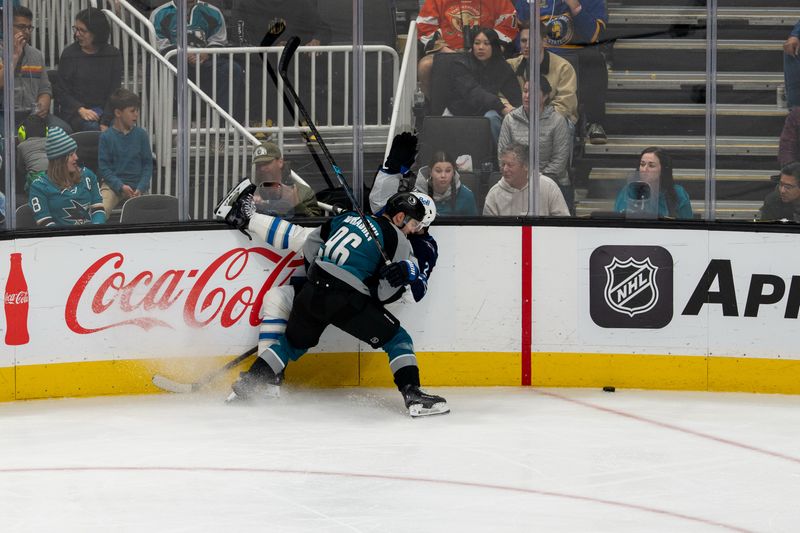 March 1, 2026; San Jose, California, USA; Winnipeg Jets defenseman Dylan DeMelo (2) is upended against the board by San Jose Sharks center Philipp Kurashev (96) during the third period at SAP Center at San Jose. Mandatory Credit: Neville E. Guard-Imagn Images