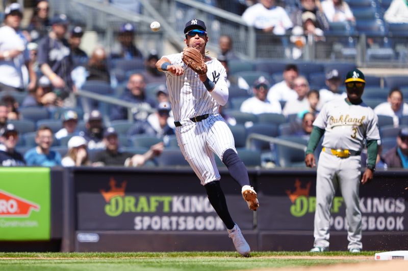 Apr 22, 2024; Bronx, New York, USA; New York Yankees third baseman Oswaldo Cabrera (95) throws to retire Oakland Athletics left fielder Tyler Nevin (not pictured) on a ground ball during the first inning at Yankee Stadium. Mandatory Credit: Gregory Fisher-USA TODAY Sports