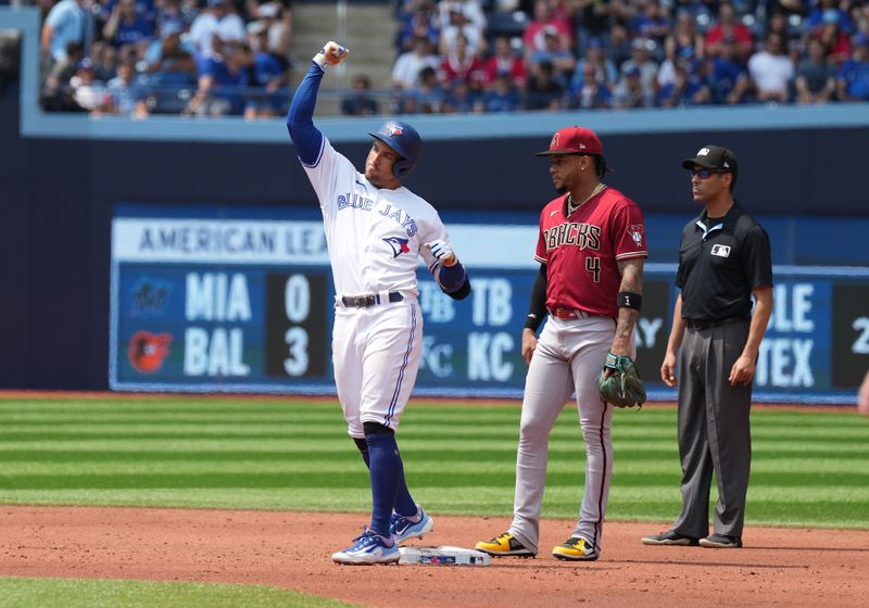 Jul 16, 2023; Toronto, Ontario, CAN; Toronto Blue Jays right fielder George Springer (4) celebrates hitting a double against the Arizona Diamondbacks during the second inning at Rogers Centre. Mandatory Credit: Nick Turchiaro-USA TODAY Sports