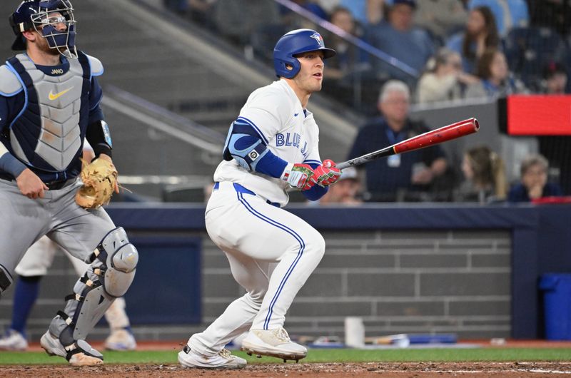 May 14, 2025; Toronto, Ontario, CAN; Toronto Blue Jays center fielder Daulton Varsho (5) hits a single against the Tampa Bay Rays in the sixth inning at Rogers Centre. Mandatory Credit: Dan Hamilton-Imagn Images