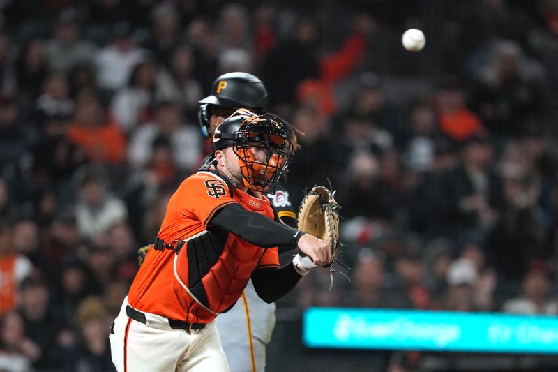 Apr 26, 2024; San Francisco, California, USA; San Francisco Giants catcher Patrick Bailey (center) throws the ball to first base to complete a double play after forcing out Pittsburgh Pirates shortstop Oneil Cruz (obscured) during the ninth inning at Oracle Park. Mandatory Credit: Darren Yamashita-USA TODAY Sports