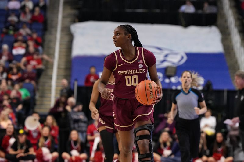 Mar 9, 2024; Greensboro, NC, USA; Florida State Seminoles guard Ta'Niya Latson (00) brings the ball up court against the NC State Wolfpack during the second half at Greensboro Coliseum. Mandatory Credit: David Yeazell-USA TODAY Sports