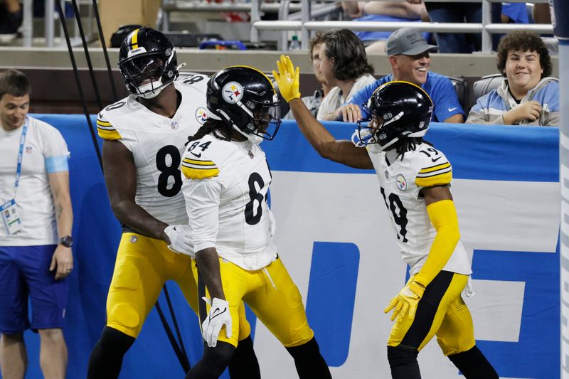 Pittsburgh Steelers running back Cordarrelle Patterson is greeted by tight end Darnell Washington (80) and wide receiver Calvin Austin III (19) after rushing for a 31-yard touchdown during the first half of an NFL preseason football game against the Detroit Lions, Saturday, Aug. 24, 2024, in Detroit. (AP Photo/Duane Burleson)