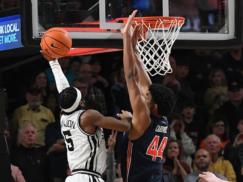 Feb 18, 2023; Nashville, Tennessee, USA; Vanderbilt Commodores guard Ezra Manjon (5) makes the game-winning shot against Auburn Tigers center Dylan Cardwell (44) late in the second half at Memorial Gymnasium. Mandatory Credit: Christopher Hanewinckel-USA TODAY Sports