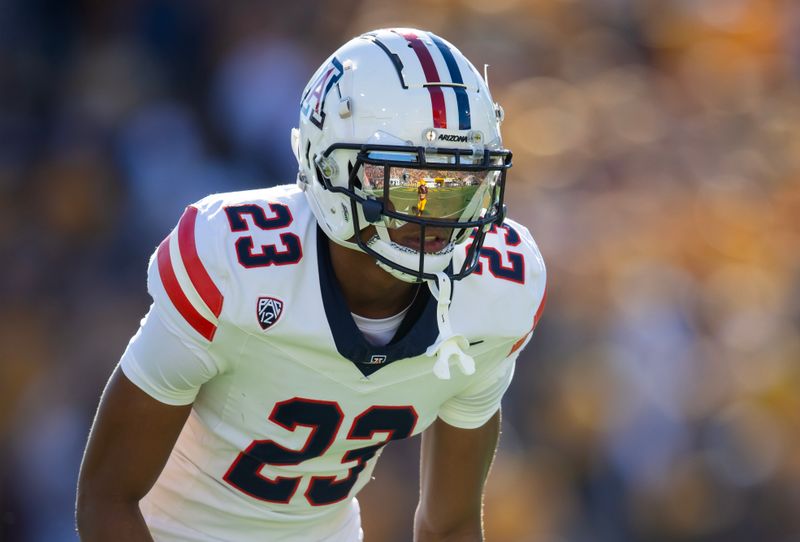 Nov 25, 2023; Tempe, Arizona, USA; An Arizona State Sun Devils player reflects in the helmet visor of Arizona Wildcats cornerback Tacario Davis (23) in the first half of the Territorial Cup at Mountain America Stadium. Mandatory Credit: Mark J. Rebilas-USA TODAY Sports