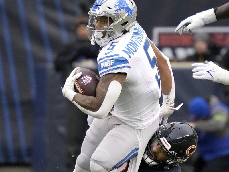 Detroit Lions running back David Montgomery carries the ball as Chicago Bears defensive end Montez Sweat makes the tackle during the first half of an NFL football game Sunday, Dec. 10, 2023, in Chicago. (AP Photo/Nam Y. Huh)