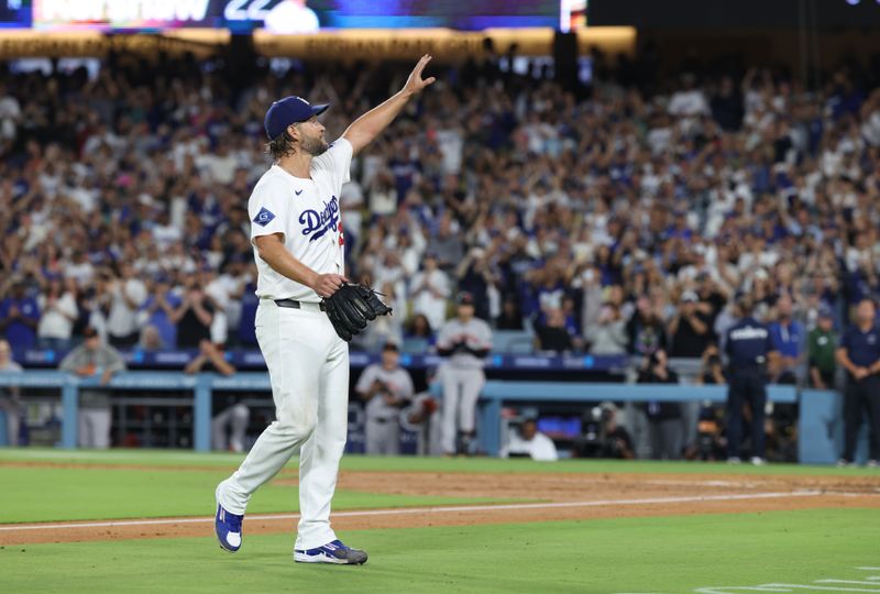 Sep 19, 2025; Los Angeles, California, USA; Los Angeles Dodgers pitcher Clayton Kershaw (22) salutes the crowd after being relieved during the fifth inning against the San Francisco Giants at Dodger Stadium. Mandatory Credit: Kiyoshi Mio-Imagn Images