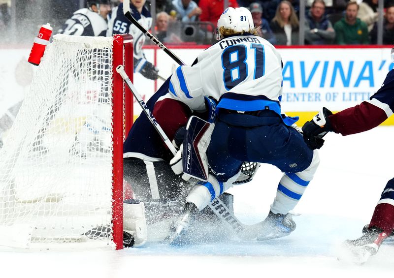 Dec 7, 2023; Denver, Colorado, USA; Winnipeg Jets left wing Kyle Connor (81) collides into Colorado Avalanche goaltender Alexandar Georgiev (40) in the third period at Ball Arena. Mandatory Credit: Ron Chenoy-USA TODAY Sports