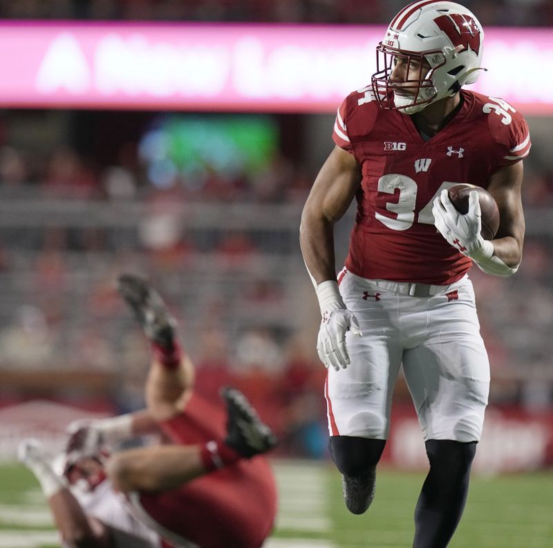 Nov 18, 2023; Madison, Wisconsin, USA; Wisconsin's Jackson Acker (34) scores a touchdown on a 26-yard reception during the second quarter of their game against Nebraska at Camp Randall Stadium. Mandatory Credit: Mark Hoffman/Milwaukee Journal Sentinel via USA TODAY NETWORK