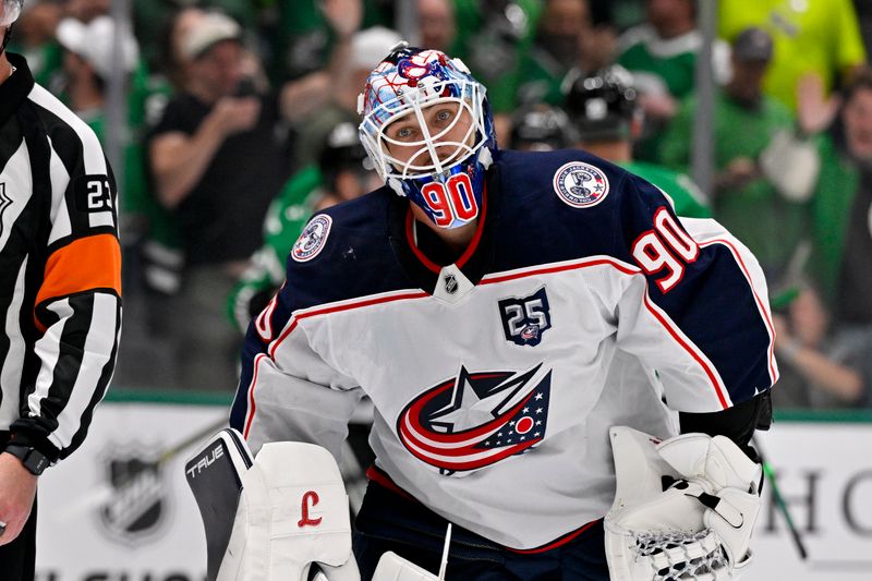 Oct 21, 2025; Dallas, Texas, USA; Columbus Blue Jackets goaltender Elvis Merzlikins (90) reacts to giving up a goal to Dallas Stars center Tyler Seguin (91) during the second period at the American Airlines Center. Mandatory Credit: Jerome Miron-Imagn Images
