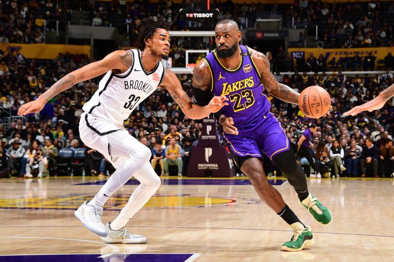 LOS ANGELES, CA - JANUARY 17: LeBron James #23 of the Los Angeles Lakers dribbles the ball during the game against the Brooklyn Nets on January 17, 2025 at Crypto.Com Arena in Los Angeles, California. NOTE TO USER: User expressly acknowledges and agrees that, by downloading and/or using this Photograph, user is consenting to the terms and conditions of the Getty Images License Agreement. Mandatory Copyright Notice: Copyright 2025 NBAE (Photo by Adam Pantozzi/NBAE via Getty Images)