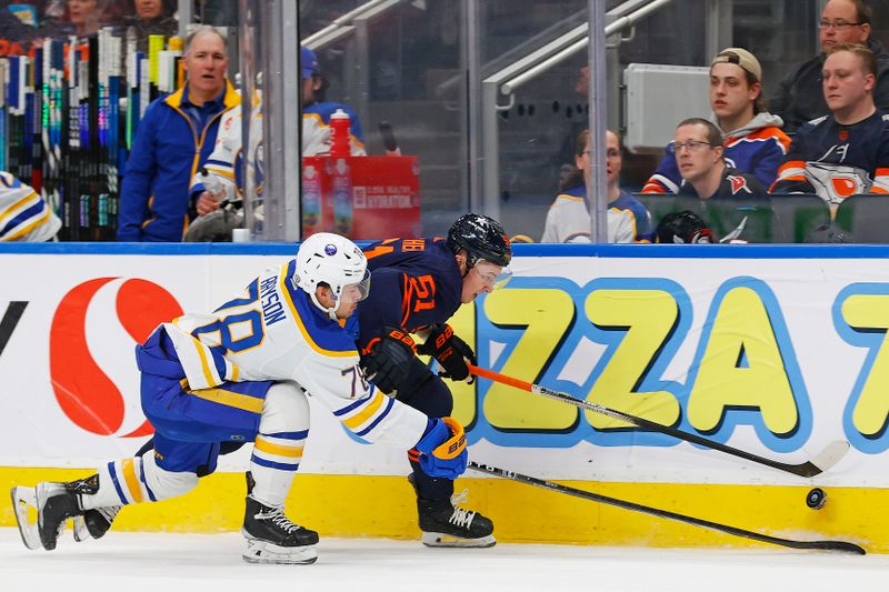 Mar 21, 2024; Edmonton, Alberta, CAN; Buffalo Sabres defensemen Jacob Bryson (78) and Edmonton Oilers defensemen Troy Stecher (51) battle for a loose puck  during the first period at Rogers Place. Mandatory Credit: Perry Nelson-USA TODAY Sports