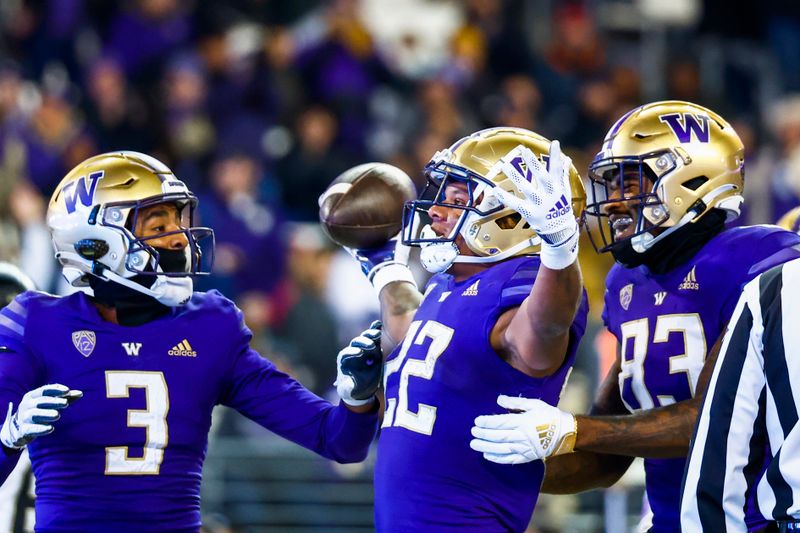 Nov 19, 2022; Seattle, Washington, USA; Washington Huskies running back Cameron Davis (22) celebrates with wide receiver Taj Davis (3) and tight end Devin Culp (83) after rushing for a touchdown against the Colorado Buffaloes during the third quarter at Alaska Airlines Field at Husky Stadium. Mandatory Credit: Joe Nicholson-USA TODAY Sports