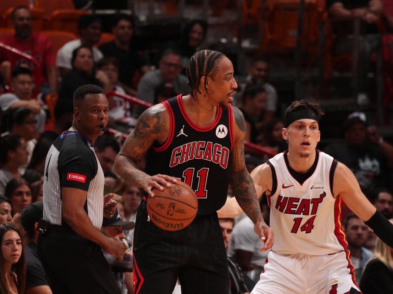 MIAMI, FL - APRIL 19: DeMar DeRozan #11 of the Chicago Bulls handles the ball against Tyler Herro #14 of the Miami Heat during the game during the 2024 Play-In Tournament on April 19, 2024 at Kaseya Center in Miami, Florida. NOTE TO USER: User expressly acknowledges and agrees that, by downloading and or using this Photograph, user is consenting to the terms and conditions of the Getty Images License Agreement. Mandatory Copyright Notice: Copyright 2024 NBAE (Photo by Issac Baldizon/NBAE via Getty Images)