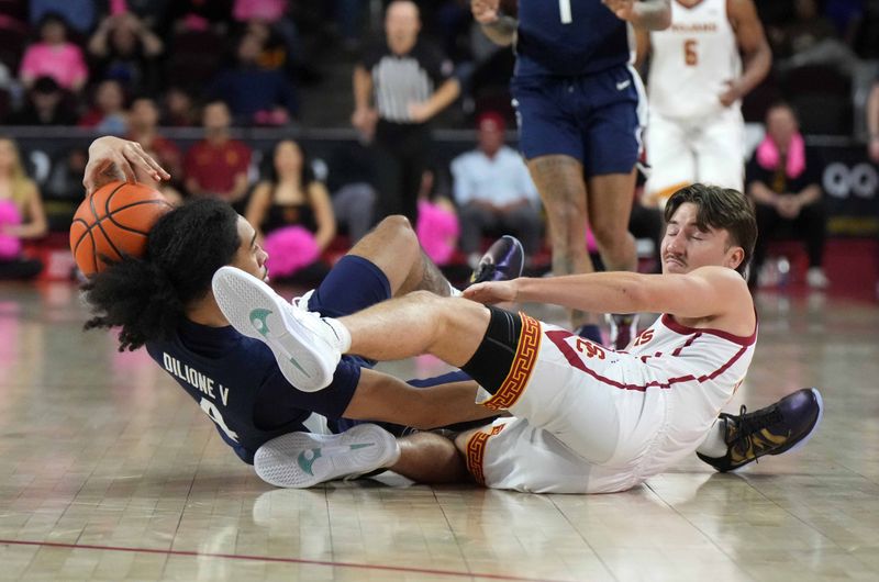 Feb 11, 2025; Los Angeles, California, USA; Southern California Trojans guard Clark Slajchert (32) and Penn State Nittany Lions guard Freddie Dilione V (4) battle for the ball in the first half at Galen Center. Mandatory Credit: Kirby Lee-Imagn Images