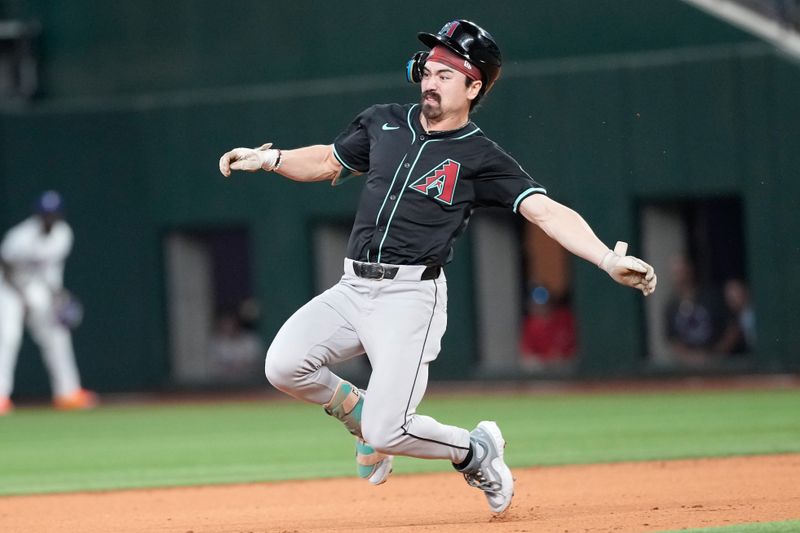 May 29, 2024; Arlington, Texas, USA; Arizona Diamondbacks center fielder Corbin Carroll (7) starts his slide to second base for a double against the Texas Rangers during the third inning at Globe Life Field. Mandatory Credit: Jim Cowsert-USA TODAY Sports