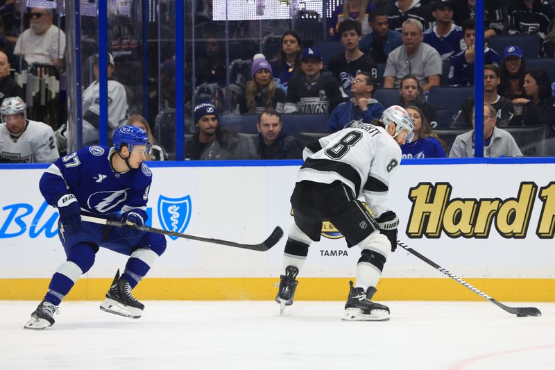 Dec 18, 2025; Tampa, Florida, USA; Los Angeles Kings defenseman Drew Doughty (8) skates with the puck as Tampa Bay Lightning center Yanni Gourde (37) defends during the first period at Benchmark International Arena. Mandatory Credit: Kim Klement Neitzel-Imagn Images