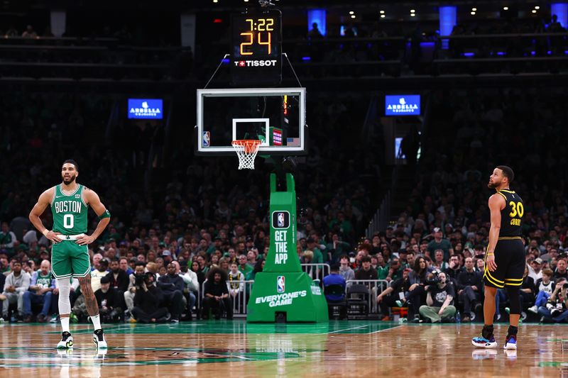 BOSTON, MASSACHUSETTS - MARCH 03: Jayson Tatum #0 of the Boston Celtics and Stephen Curry #30 of the Golden State Warriors look on during the first quarter at TD Garden on March 03, 2024 in Boston, Massachusetts. NOTE TO USER: User expressly acknowledges and agrees that, by downloading and or using this photograph, user is consenting to the terms and conditions of the Getty Images License Agreement.  (Photo by Maddie Meyer/Getty Images)