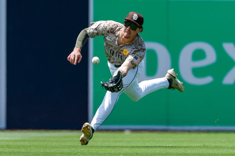 May 26, 2024; San Diego, California, USA; San Diego Padres center fielder Jackson Merrill (3) makes a diving catch in the fourth inning against the New York Yankees at Petco Park. Mandatory Credit: David Frerker-USA TODAY Sports