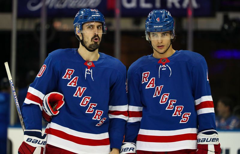 Apr 5, 2023; New York, New York, USA; New York Rangers left wing Chris Kreider (20) and defenseman Braden Schneider (4) await a face-off against the Tampa Bay Lightning during the second period at Madison Square Garden. Mandatory Credit: Danny Wild-USA TODAY Sports