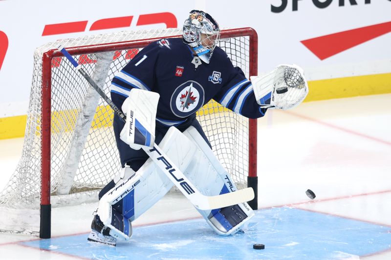 Nov 21, 2025; Winnipeg, Manitoba, CAN; Winnipeg Jets goaltender Eric Comrie (1) warms up before a game against the Carolina Hurricanes at Canada Life Centre. Mandatory Credit: James Carey Lauder-Imagn Images
