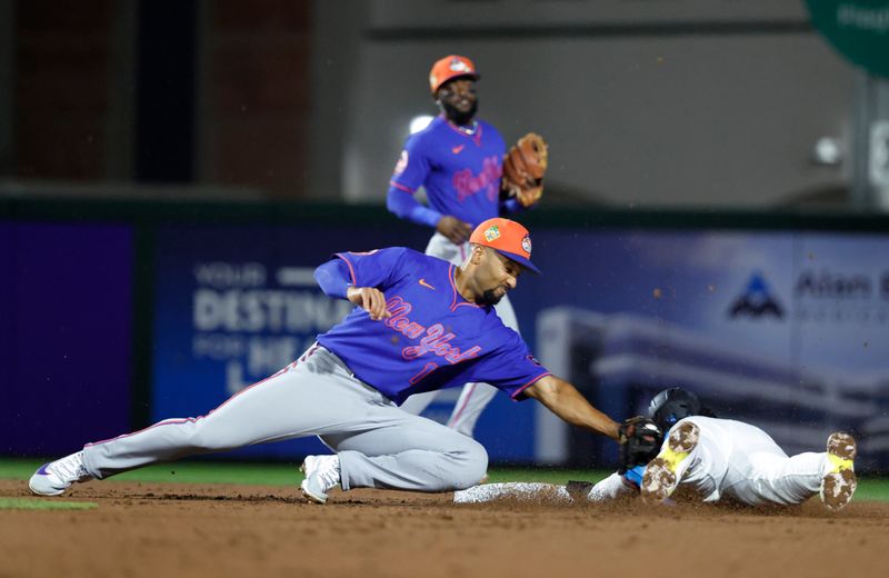 Mar 6, 2026; Jupiter, Florida, USA;  New York Mets second baseman Marcus Semien (10) tags out Miami Marlins shortstop Maximo Acosta (24) trying to steal second base during the second inning at Roger Dean Chevrolet Stadium. Mandatory Credit: Rhona Wise-Imagn Images
