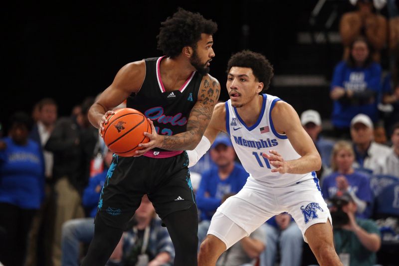 Feb 25, 2024; Memphis, Tennessee, USA; Florida Atlantic Owls guard Jalen Gaffney (12) handles the ball as Memphis Tigers guard Jahvon Quinerly (11) defends during the first half at FedExForum. Mandatory Credit: Petre Thomas-USA TODAY Sports