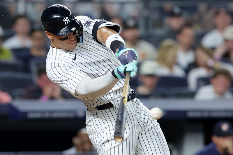 May 8, 2024; Bronx, New York, USA; New York Yankees center fielder Aaron Judge (99) hits a two run double against the Houston Astros during the sixth inning at Yankee Stadium. Mandatory Credit: Brad Penner-USA TODAY Sports